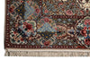 Load image into Gallery viewer, A close-up of an ornate Persian-style area rug showing its detailed floral and geometric patterns in beige, blue, red, and green, with cream-colored fringe at the bottom.