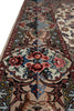 Load image into Gallery viewer, A close-up view of an ornate traditional area rug with a cream base, featuring a central floral medallion in red, pink, and blue, surrounded by detailed borders.