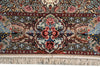 Load image into Gallery viewer, A close-up of an ornate Persian-style rug with a central floral medallion, intricate scrollwork, and cream fringe along the bottom edge.