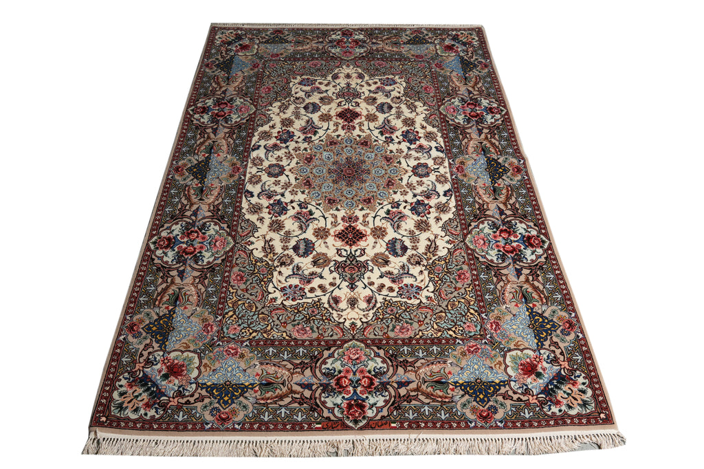 An oriental area rug with an intricate floral and medallion pattern, featuring a cream center, red borders, and blue accents, finished with a fringed edge.