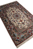 Load image into Gallery viewer, An ornate rectangular area rug with a traditional Persian-style floral pattern, featuring a cream center, blue and red floral motifs, and a dark border with fringe on a white background.