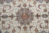 Load image into Gallery viewer, A close-up of an ornate traditional patterned rug with a central medallion and surrounding floral motifs in cream, blue, rust red, and brown.