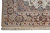 Load image into Gallery viewer, A close-up of an ornate patterned area rug corner showing detailed floral motifs, borders, and cream-colored fringe.
