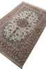 Load image into Gallery viewer, An oriental-style area rug with a traditional floral and vine pattern, featuring a central medallion and fringed edges, shown from an overhead angle on a white background.
