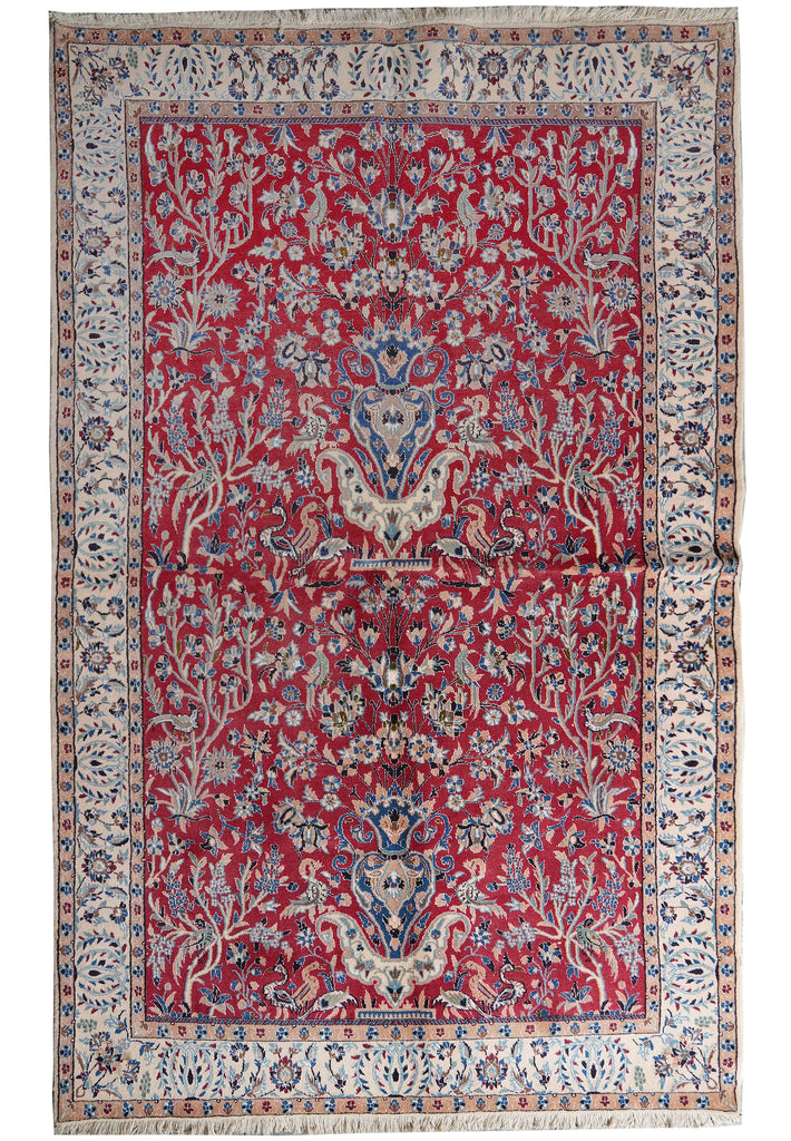 A traditional oriental area rug with a deep red field, featuring a central medallion, floral motifs, and an ornate patterned border in cream, blue, and beige tones.