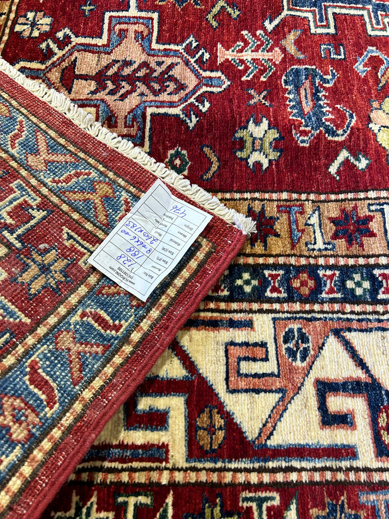 Super Kazak Rug as a Statement Piece in a Boutique: "Fashionable boutique interior with a statement 6x9 red Super Kazak rug, elevating the shopping experience with its bold design and color."