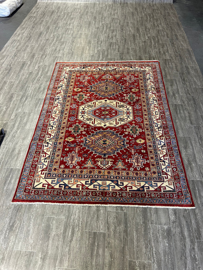 Image of a Modern Bedroom with Red Rug: "Modern bedroom design with a 6x9 red Super Kazak rug under the bed, adding warmth and style to the minimalist decor."