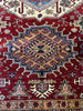 Load image into Gallery viewer, Detail of Super Kazak Rug Pattern and Color: &quot;Close-up view of the detailed geometric pattern and rich red hues of a 6x9 Super Kazak rug, exemplifying traditional design.&quot;