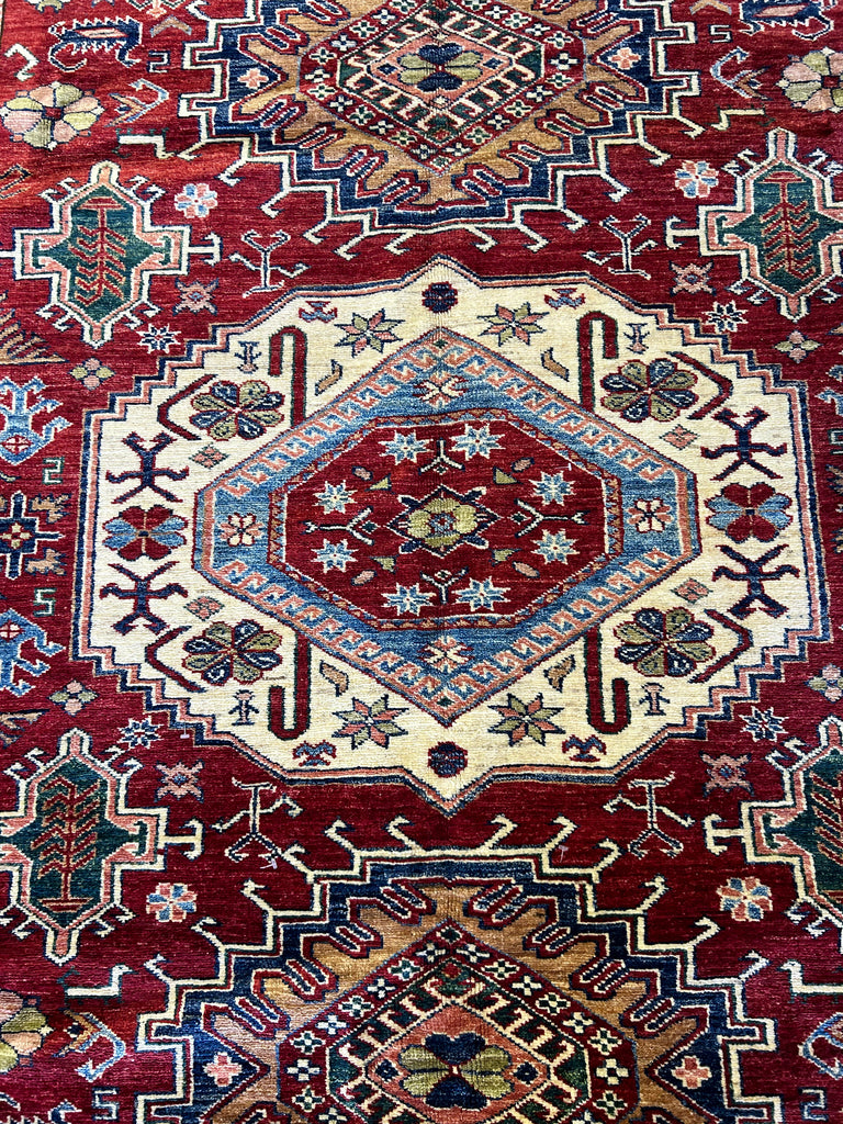 Dining Room Enhanced by Super Kazak Rug: "Elegant dining room set upon a luxurious 6x9 red Super Kazak rug, blending traditional and contemporary styles in home decor."