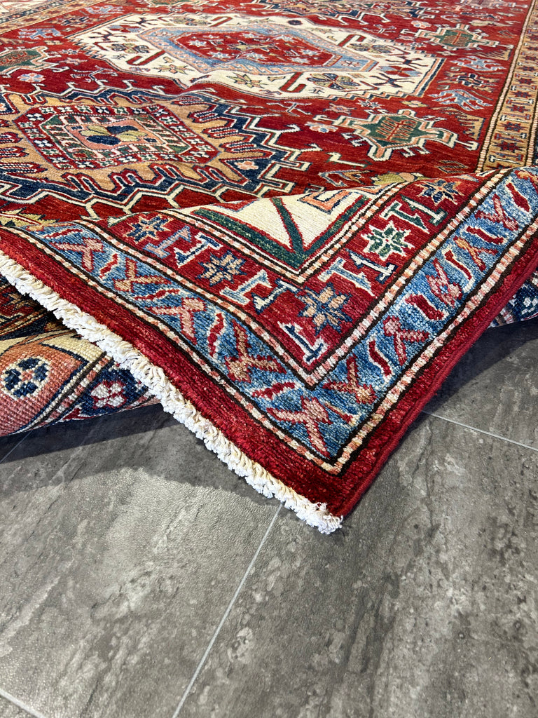 Stylish Home Office with Red Kazak Rug: "Stylish home office space enhanced by a vibrant 6x9 red Super Kazak rug, adding comfort and sophistication to the work environment."