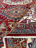 Load image into Gallery viewer, Close-up of Super Kazak Rug&#39;s Weave: &quot;Detailed close-up of the intricate weave and vibrant red pattern of a handmade 6x9 Super Kazak wool rug, showcasing craftsmanship.&quot;
