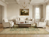 Load image into Gallery viewer, Living room with white sofa, armchairs, and a coffee table on a patterned rug.