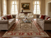 Load image into Gallery viewer, Living room with beige sofas, armchairs, and a large rug.