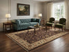 Load image into Gallery viewer, Living room with a blue sofa, green chairs, and a large rug.