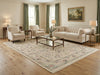 Load image into Gallery viewer, Living room with beige sofa, armchairs, and coffee table on a large patterned rug.