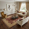 Load image into Gallery viewer, Living room with beige sofas, armchair, coffee table, and decorative elements.