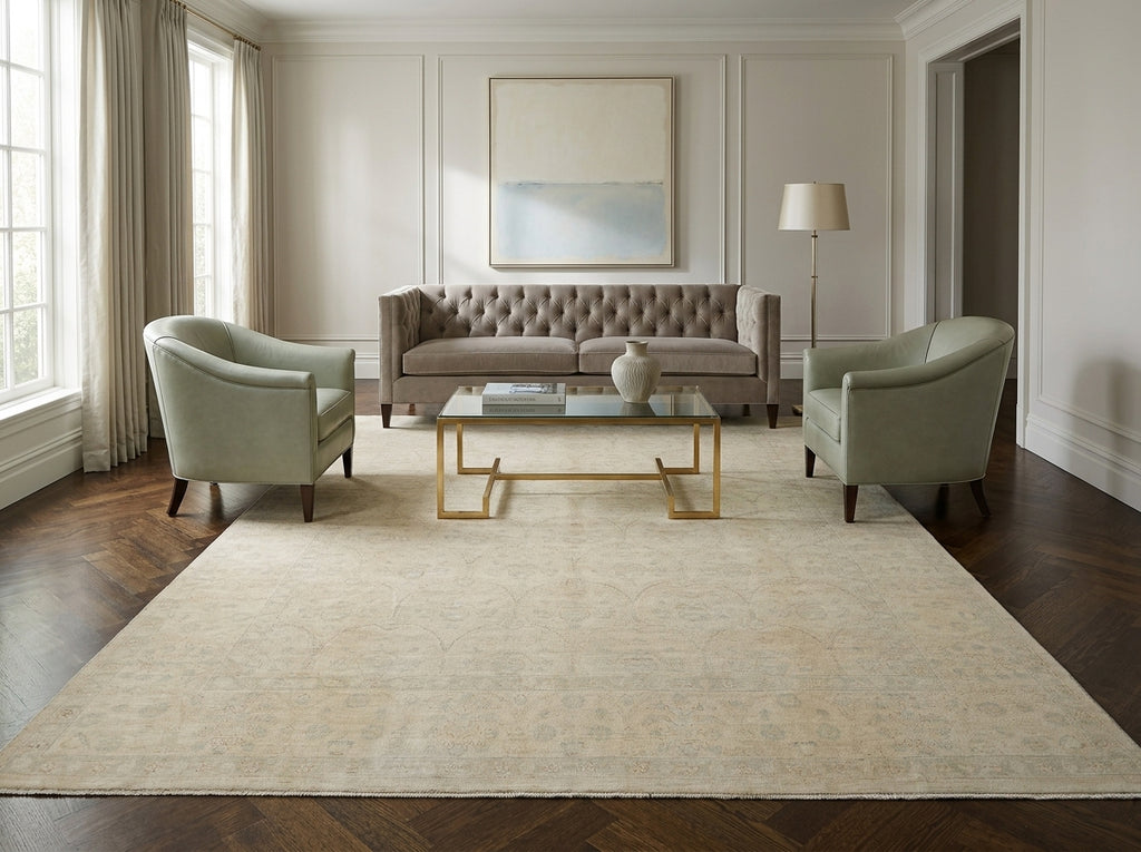 Living room with a beige rug, gray sofa, and two armchairs.