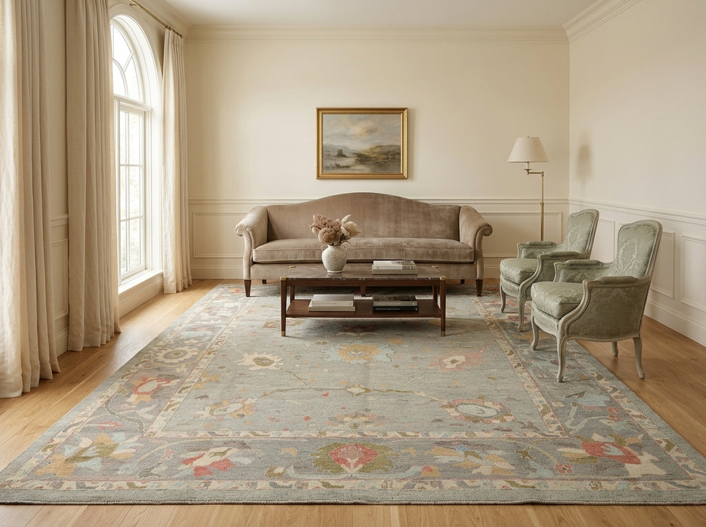 Living room with a floral rug, sofa, and armchairs.