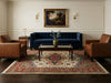 Load image into Gallery viewer, Living room with blue sofa, brown armchairs, and decorative rug.