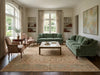 Load image into Gallery viewer, Living room with green sofas, wooden coffee table, and large windows.