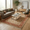 Load image into Gallery viewer, Living room with a patterned rug, sofa, coffee table, and decorative items.