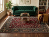 Load image into Gallery viewer, Green velvet sofa in a living room with a patterned rug, coffee table, and bookshelf.