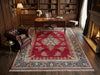Load image into Gallery viewer, A large traditional oriental area rug with a red field, beige and blue floral motifs, and white fringe, styled in a classic wood-paneled study with a leather armchair, desk, and fireplace.