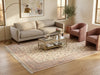 Load image into Gallery viewer, A styled living room scene featuring a large beige and pink patterned area rug on a light wood floor.