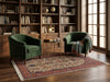 Load image into Gallery viewer, A styled interior scene with two dark green velvet armchairs placed on a large patterned area rug in a book-filled room. A small round side table sits between them, and a throw blanket rests over the right chair.