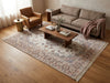 Load image into Gallery viewer, A large traditional-style area rug with an intricate floral and medallion pattern in beige, dusty pink, and muted blue, styled in a warm, modern living room.