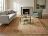 Load image into Gallery viewer, A large traditional-style area rug in beige, rust, and muted red tones, styled in a bright living room.