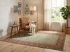 Load image into Gallery viewer, A traditional area rug with a muted sage green center and a red, blue, and beige patterned border.