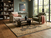 Load image into Gallery viewer, A styled living room scene featuring a large traditional area rug in beige, brown, and muted blue tones.