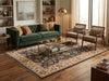 Load image into Gallery viewer, A styled living room featuring a deep green velvet tufted sofa, two mid-century modern armchairs, a patterned area rug, and a glass-top coffee table on a hardwood floor.