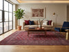 Load image into Gallery viewer, A styled living room featuring a large traditional-style area rug with a red and purple floral pattern, a beige sofa.
