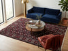 Load image into Gallery viewer, A large traditional-style area rug with a dark red and beige geometric pattern is styled in a bright living room.