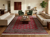 Load image into Gallery viewer, A large traditional-style area rug with a red, beige, and gray geometric pattern and fringe, styled in a modern living room with two beige sofas, green armchairs, and a wooden coffee table.
