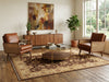 Load image into Gallery viewer, A mid-century modern living room setup featuring a large distressed brown and beige area rug on a wooden floor. 
