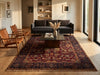 Load image into Gallery viewer, A large traditional oriental area rug with a deep red and navy blue pattern, styled in a modern living room with a dark gray sofa, wooden chairs, and light wood floors.