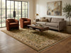Load image into Gallery viewer, A styled living room featuring a large traditional oriental area rug in beige, brown, and muted blue tones, paired with a gray sofa, two rust-orange armchairs, a dark wood coffee table, and a large window in the background.