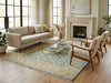 Load image into Gallery viewer, Living room with beige sofa, wooden chairs, glass coffee table, and fireplace.