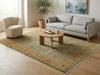 Load image into Gallery viewer, Living room with a gray sofa, round wooden coffee table, and patterned rug.