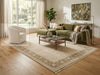 Load image into Gallery viewer, Living room with green sofa, white armchair, and coffee table on a large rug.
