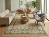 Load image into Gallery viewer, Living room with a patterned rug, beige sofa, and wooden coffee table.