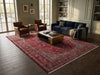 Load image into Gallery viewer, A large traditional Persian-style area rug with a red and beige floral pattern, displayed in a beautifully styled living room.