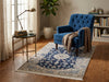Load image into Gallery viewer, A blue and beige patterned area rug in a cozy living room.