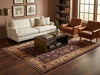 Load image into Gallery viewer, A styled living room scene featuring a large traditional patterned area rug on dark hardwood flooring.
