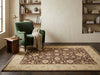 Load image into Gallery viewer, A rectangular area rug with a distressed traditional floral pattern in brown and beige.
