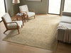 Load image into Gallery viewer, A large rectangular area rug with an ornate traditional pattern in beige, cream, and muted blue-gray tones, styled in a modern living room setting with light wood floors, two armchairs, and a sofa.