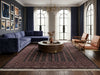Load image into Gallery viewer, A styled living room featuring a large dark blue velvet sectional sofa, two tan leather armchairs with gold frames, a round wooden coffee table, and a large patterned area rug in dark red and brown tones. The room has tall arched windows with navy blue drapes, a chandelier, and framed wall art.
